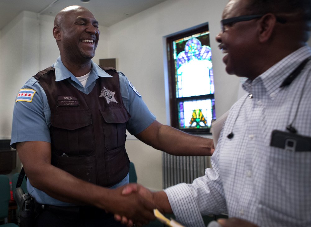  After a CAPS community meeting, Officer Bolin embraces a member of the neighborhood.&nbsp;The meeting helps to provide understanding of policing strategies used by officers. Members also agreed to report suspicious activities to authorities. The city of Chicago has a culture that is against reporting illegal activity. A culture that makes it difficult for officers to do their job.&nbsp;Individuals are typically scared to report crimes to officers due to fear of retaliation. 